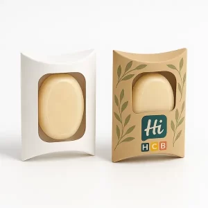 Two curved soap boxes with windows - one plain white- one kraft with green leaf design and HCB branding