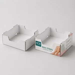 Cardboard shelf ready display trays, one blank white and one printed with pink floral patterns.