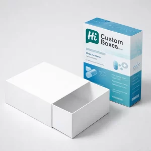 A white cardboard drawer-style box pulled open alongside a blue branded pharmaceutical sleeve.