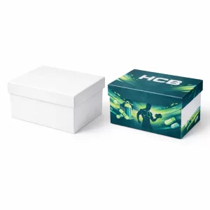 Two open flat-style boxes, one minimalist white and one with a colorful dog graphic and HCB logo.